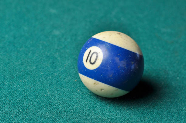istock Old billiard ball number 10 striped white and blue on green billiard table, copy space 1168287314