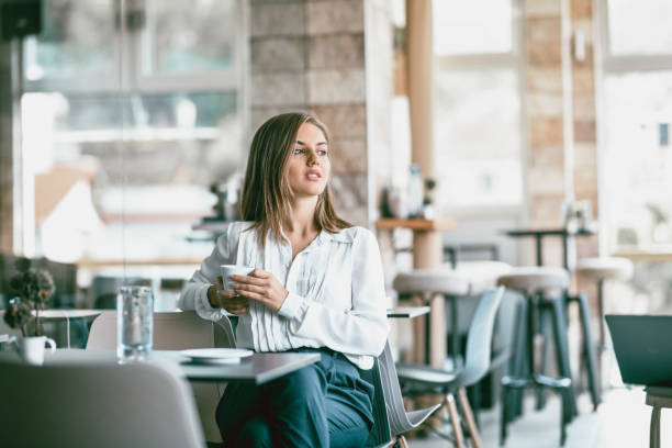 istock Female Beauty Drinking Coffee And Enjoying Tranquility In Coffee Bar 1168287370