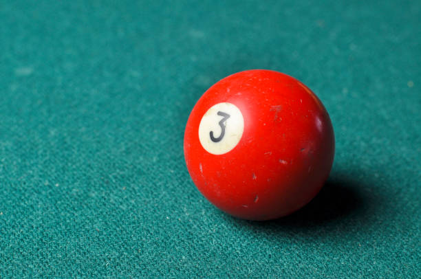 istock Old billiard ball number 3 red color on green billiard table, copy space 1168288047