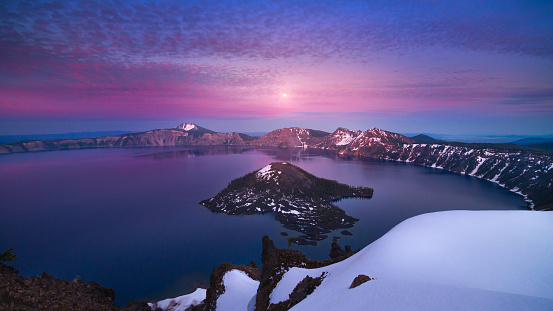 This is a photograph of a moonrise scene occurred right after sunset at Crater Lake National Park