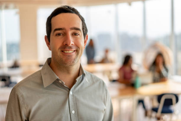 istock Handsome latin american man at the office facing camera smiling 1168290374