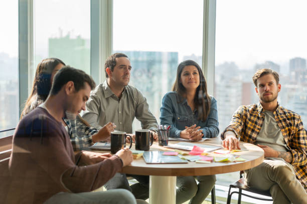 istock Young business casual group paying attention to someone during a meeting looking focused 1168290421