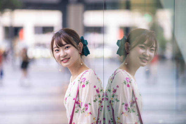 istock Young woman leaning on glass window 1168291586