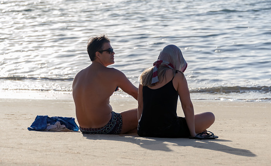 Recife, Pernambuco, Brazil - August 10, 2019: Couple enjoying the beach in the morning