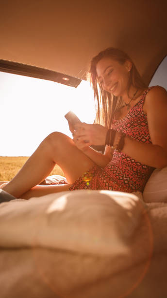 istock Happy young woman relaxing on her camping trip while using mobile phone 1168294336