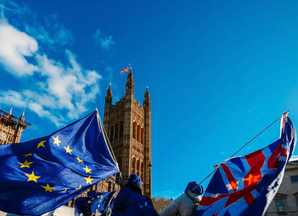 drapeau de jack de l'union européenne et de l'union britannique volant devant des chambres du parlement au palais de westminster, londres - tour victoria photos et images de collection