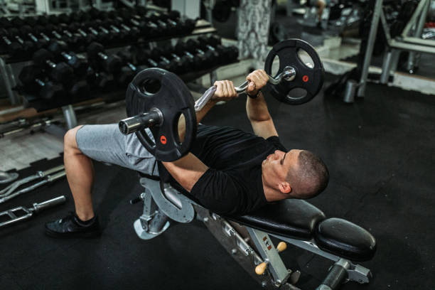istock Man lifting weights in the gym 1168299495