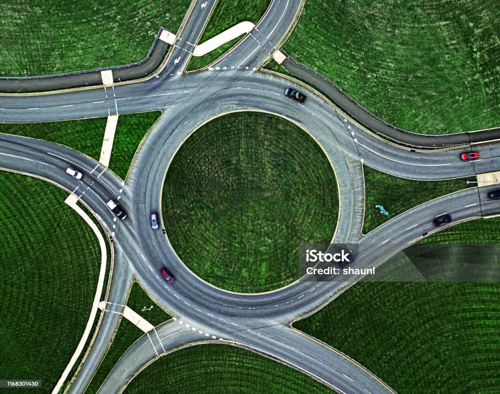 Traffic Roundabout Below Aerial view of a traffic roundabout. Circle Stock Photo