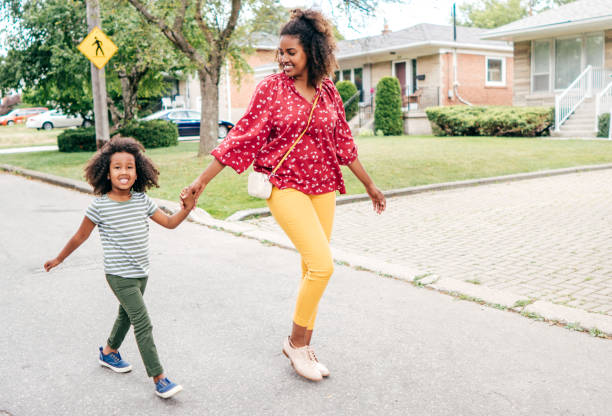 istock Holding hands - mom and daughter walking together in the morning 1168303319