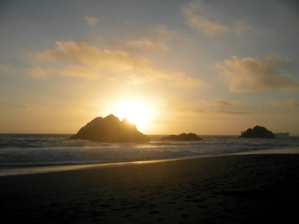 istock Sunset over Seal rock and Pacific ocean with large cargo ship in the background on Ocean Beach 1168306463