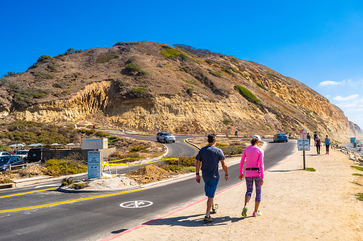 San Diego, California - October 08 2017: People at the Torrey Pines State Park Reserve in La Jolla with sandstone hill cliff landscapes, on dry hot sunny summer day.