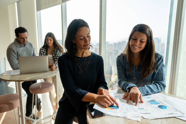 istock Female business partners going over some documents at a coworking office 1168307548