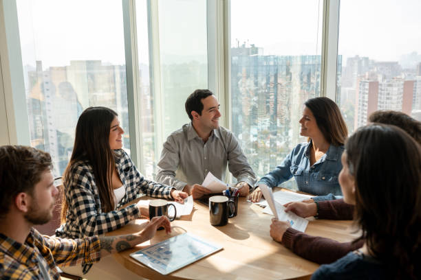 istock Successful group of people discussing business at the office all looking very cheerful 1168307575