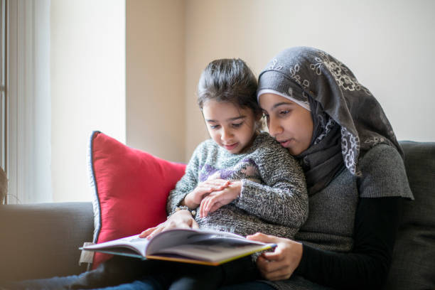 istock Muslim mother reading to her daughter 1168309135
