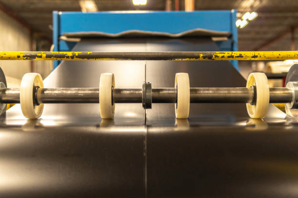 istock Roll of sheet metal being sliced cut into 2 1168310192