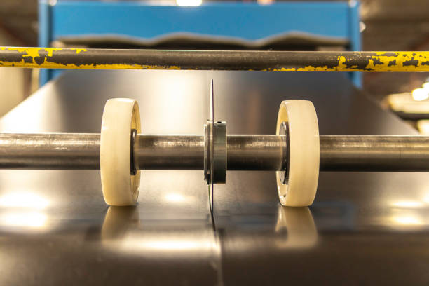 istock Roll of sheet metal being sliced cut into 2 1168310200