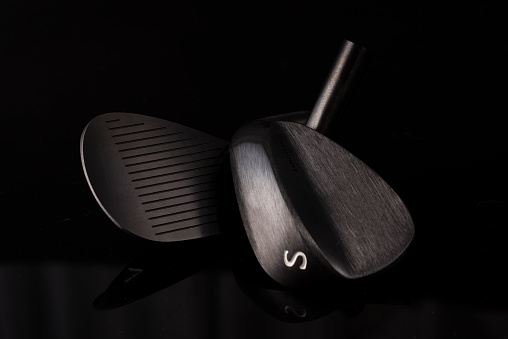 Forged Sand Wedges Heads on a Black Background. Golf Equipment