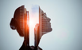 Double exposure of woman silhouette and modern city skyline.