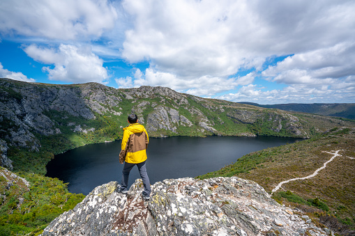 Traveller man explore landscape of Marions lookout trail in Cradle Mountain National Park in Tasmania, Australia. Summer activity and people adventure.