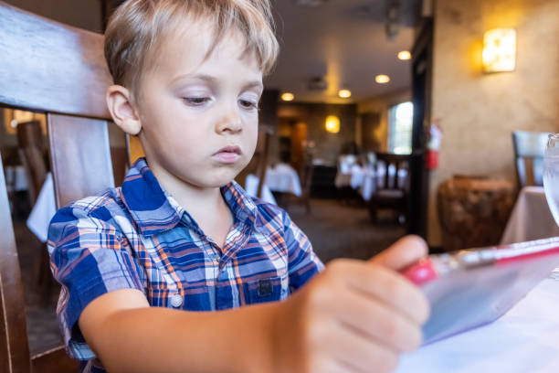 istock Little boy child looking at his smart phone 1168319796