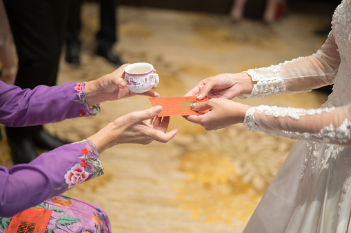 children's hands hold a rosary in a transparent bag for the first communion. Catahese