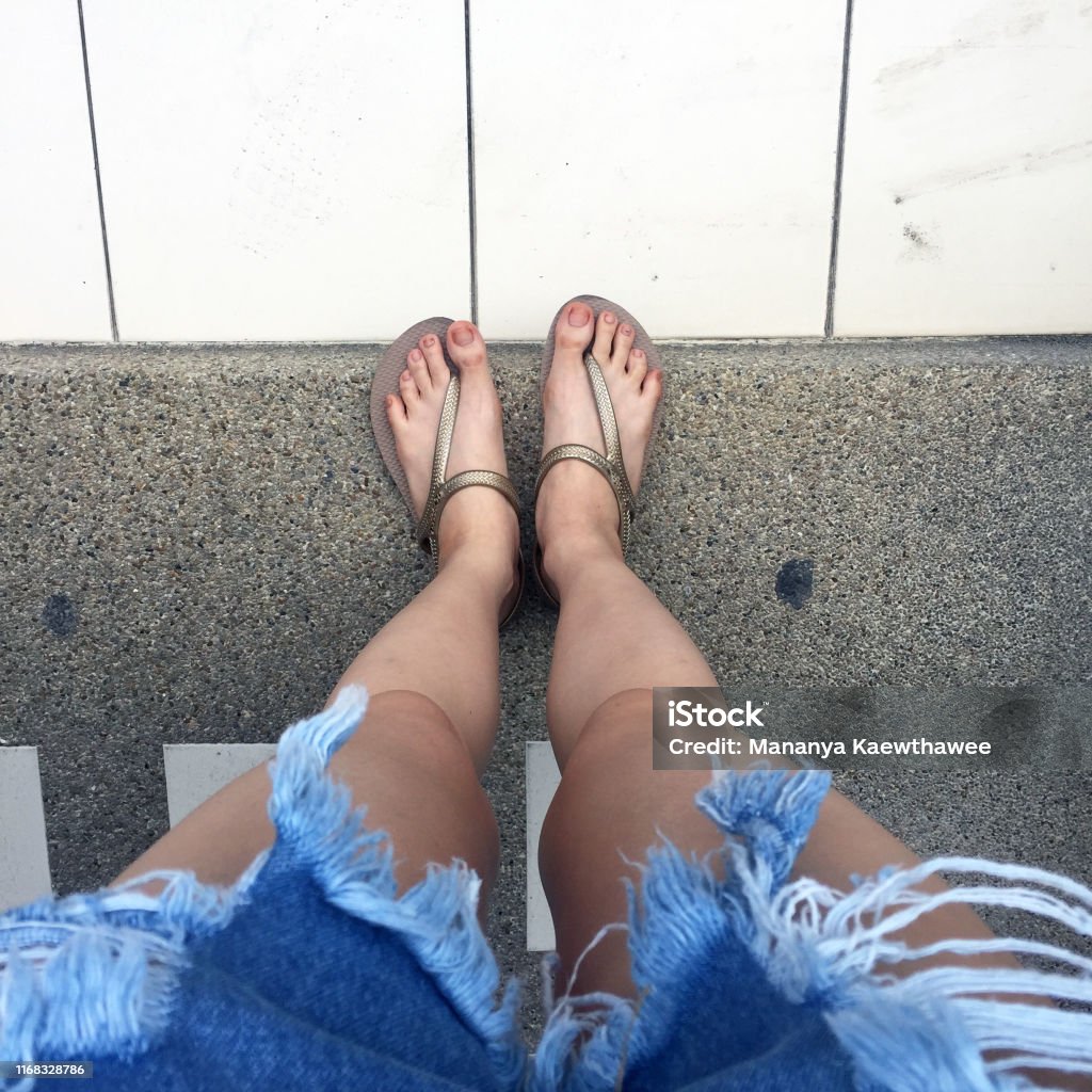 legs tween closeup Foot And Legs Seen From Above Selfie Of Feet In Fashion Beige Shoes On Concrete Background Top View Woman Standing On Road Street Stock Photo - Download Image Now - iStock