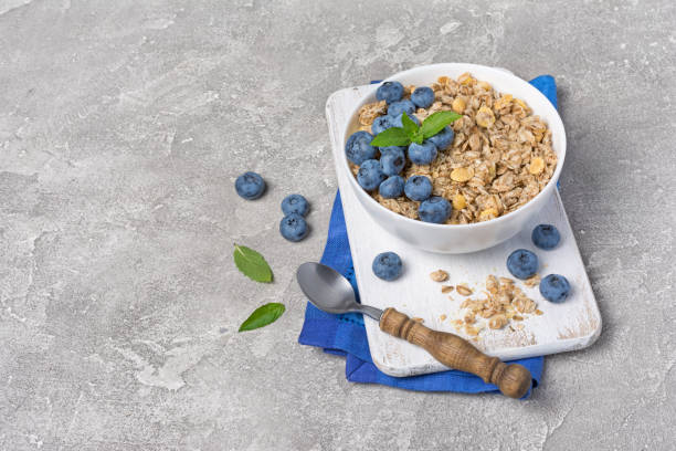 istock Oatmeal or granola with fresh blueberry in white bowl 1168330078