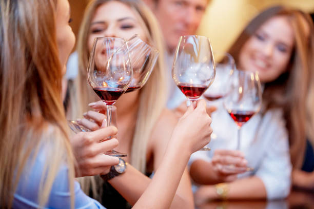 istock Proposing a toast with red wine to cheerful party 1168333034