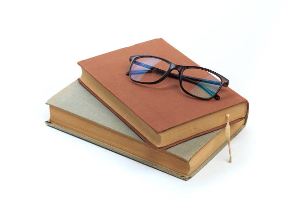 istock vintage old hardcover books with glasses on white background - Image 1168334022