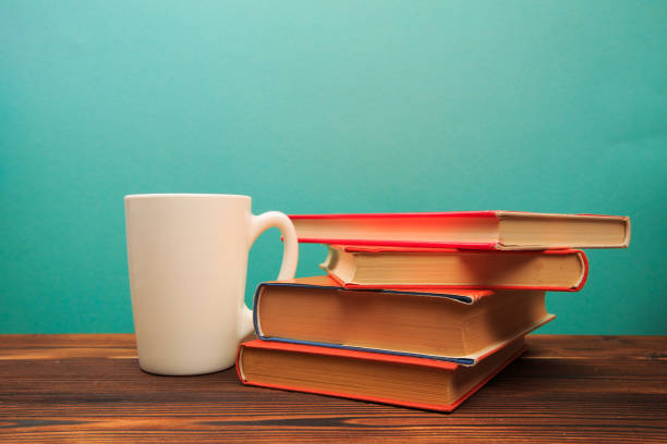 istock pile of old books with mug , panorma, good copy space  on blue background - Image 1168334051