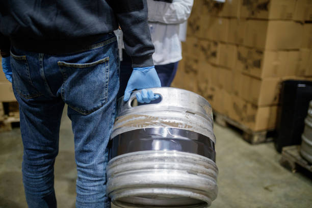 Aluminum keg in worker's hand