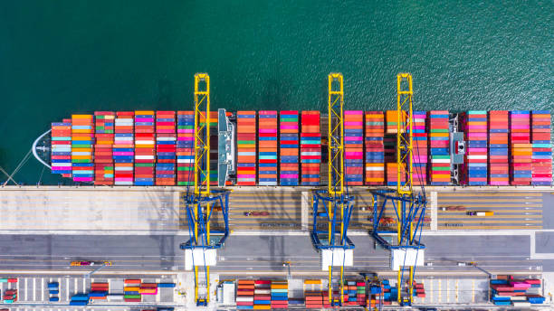 istock Container ship loading and unloading in deep sea port, Aerial top view of business logistic import and  export freight  transportation by container ship in open sea. 1168336173