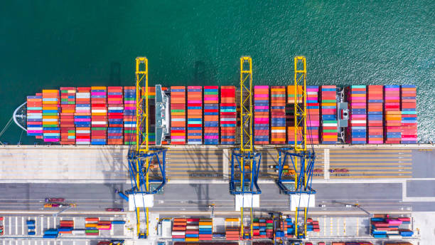 istock Container ship loading and unloading in deep sea port, Aerial top view of business logistic import and  export freight  transportation by container ship in open sea. 1168336305