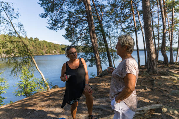 istock Senior ladies drinking coffee in a forest 1168336341
