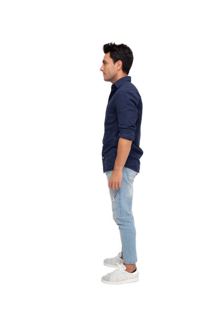 istock Side view of a young casual man standing isolated on white background 1168337510