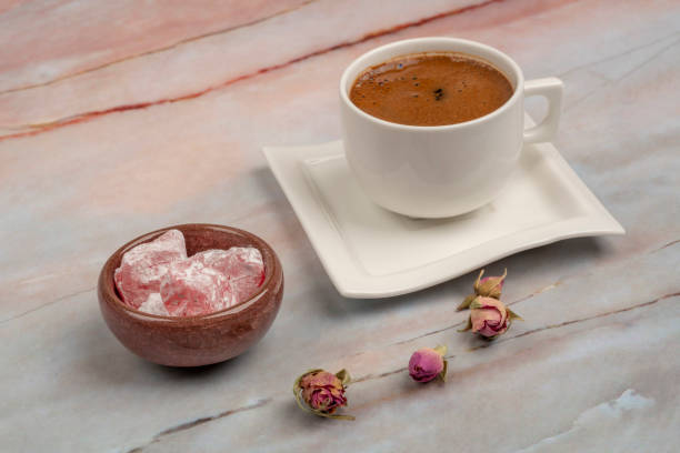 istock Turkish delight and coffee on a table decorated with roses 1168337635
