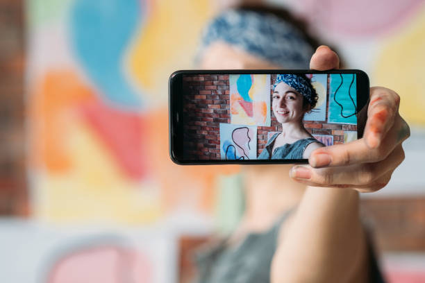 istock successful artist cheerful painter selfie artworks 1168347547