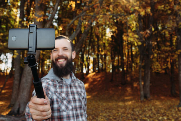istock fall nature leisure man selfie autumn forest 1168347680