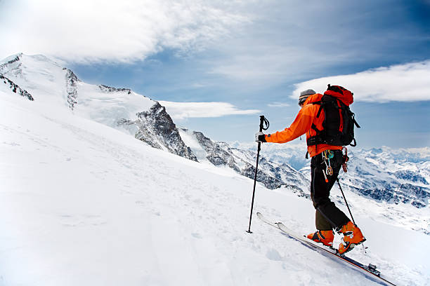 A man hiking in snowshoes up a snowy mountain Lone Alpine Touring Skier on the big Verra Glacier; in background the peaks of Castore and Polluce. MonteRosa, Swiss-Italy border. pennine alps stock pictures, royalty-free photos & images