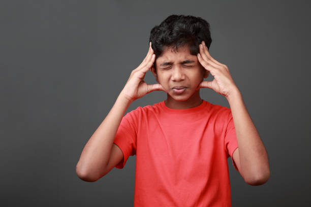 Boy with a painful face expression stock photo