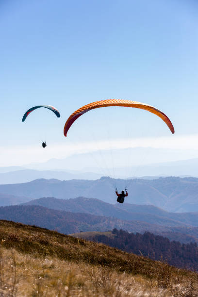 istock flying paragliders in air 1168354377
