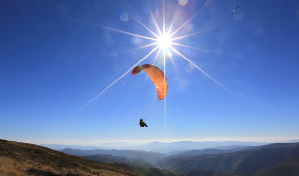 istock paraglider fly in mountains 1168354390