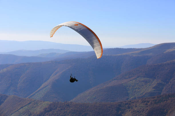 istock flying paraglider in air 1168355009