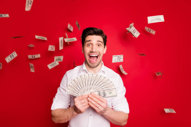 istock Photo of overjoyed nice good attractive handsome man having won lottery while isolated with red background 1168355281