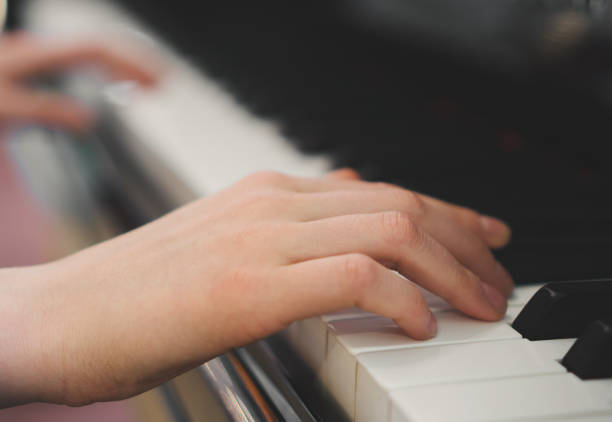 istock Little girl is playing the grand piano. 1168356302