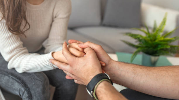 close-up of psychiatrist hands together holding palm of her patient. - holding hands human hand romance support imagens e fotografias de stock