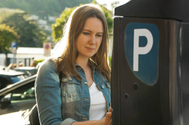 istock Woman using parking machine on the street. 1168356490