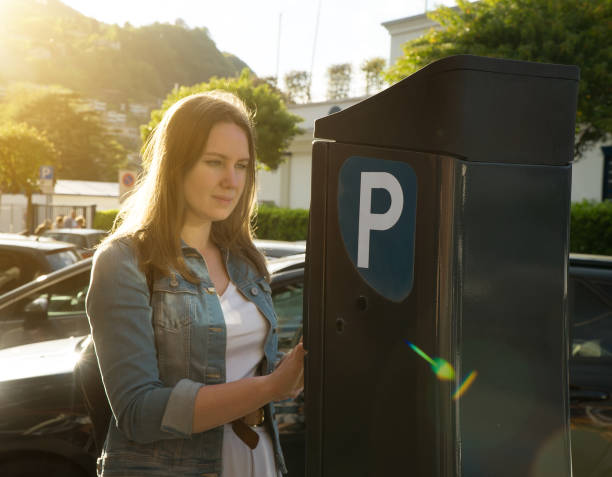 istock Woman using parking machine on the street. 1168356495