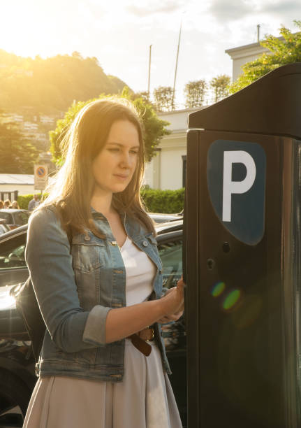 istock Woman using parking machine on the street. 1168356498