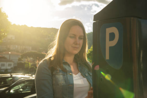 istock Woman using parking machine on the street. 1168356499